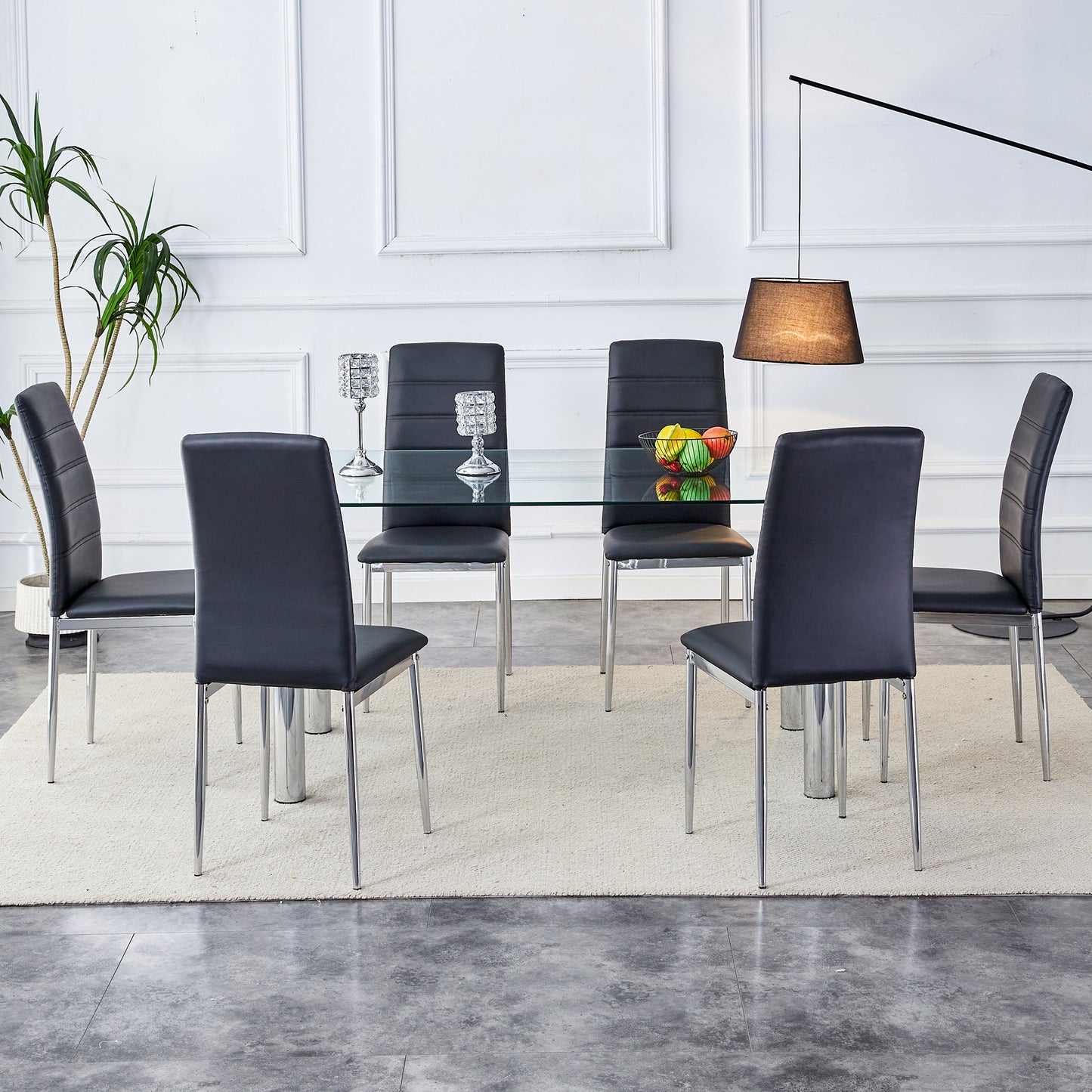 A modern minimalist style glass dining table. Transparent tempered glass tabletop with a thickness of 0.3 feet and silver metal legs. Suitable for restaurants and living rooms. 63 "* 35.4" * 30"